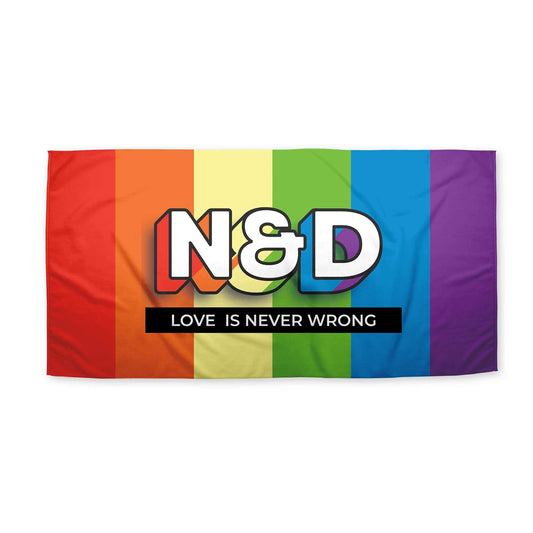 An LGBT Beach Towel with rainbow patterns and 'N&D' written, with a caption 'love is never wrong', displayed on a white surface