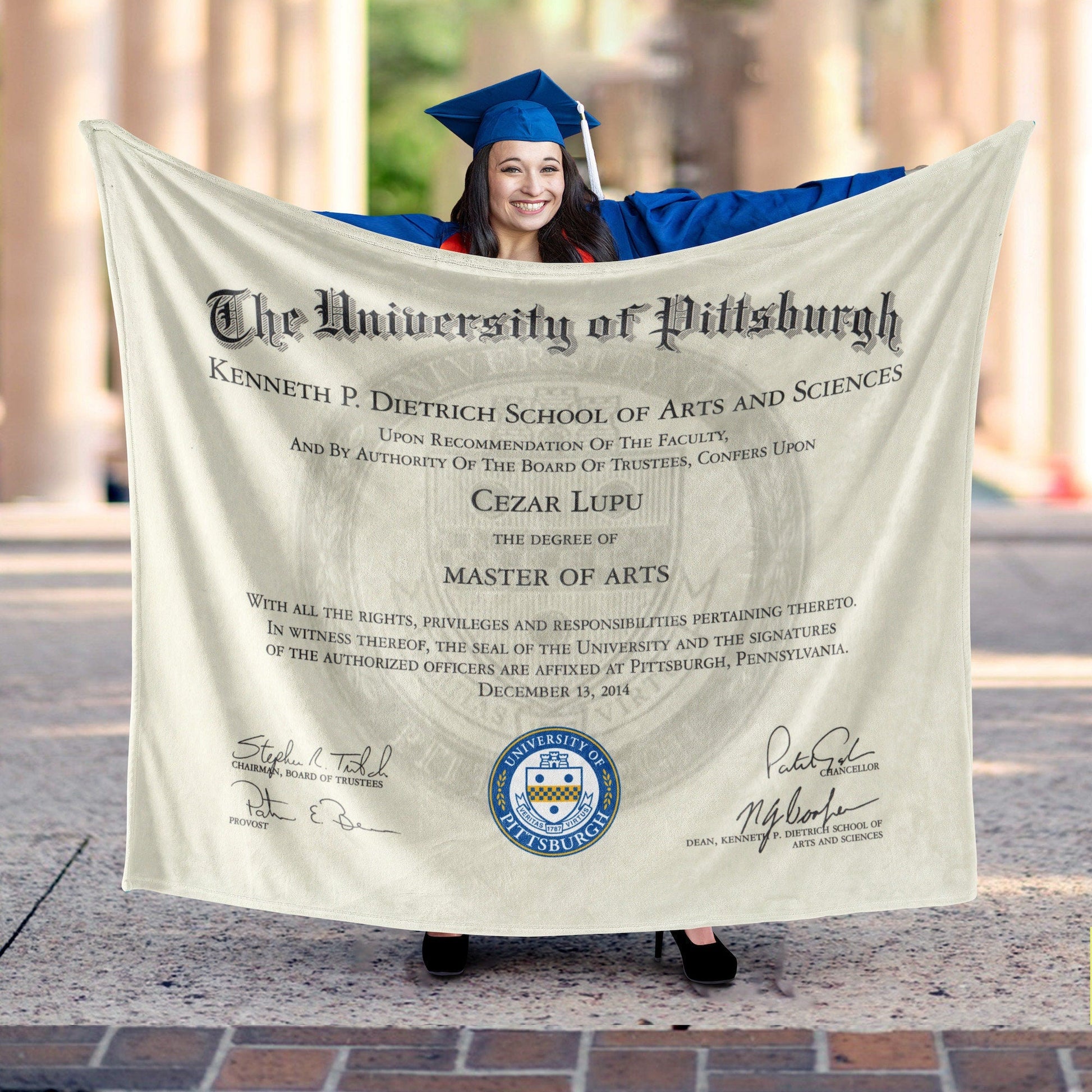 Person holding a cozy throw blanket with diploma certificate design