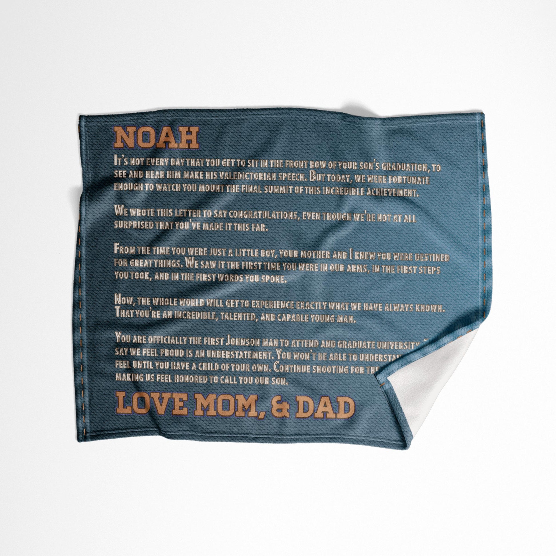 A custom letter denim throw blanket design displayed on a white surface