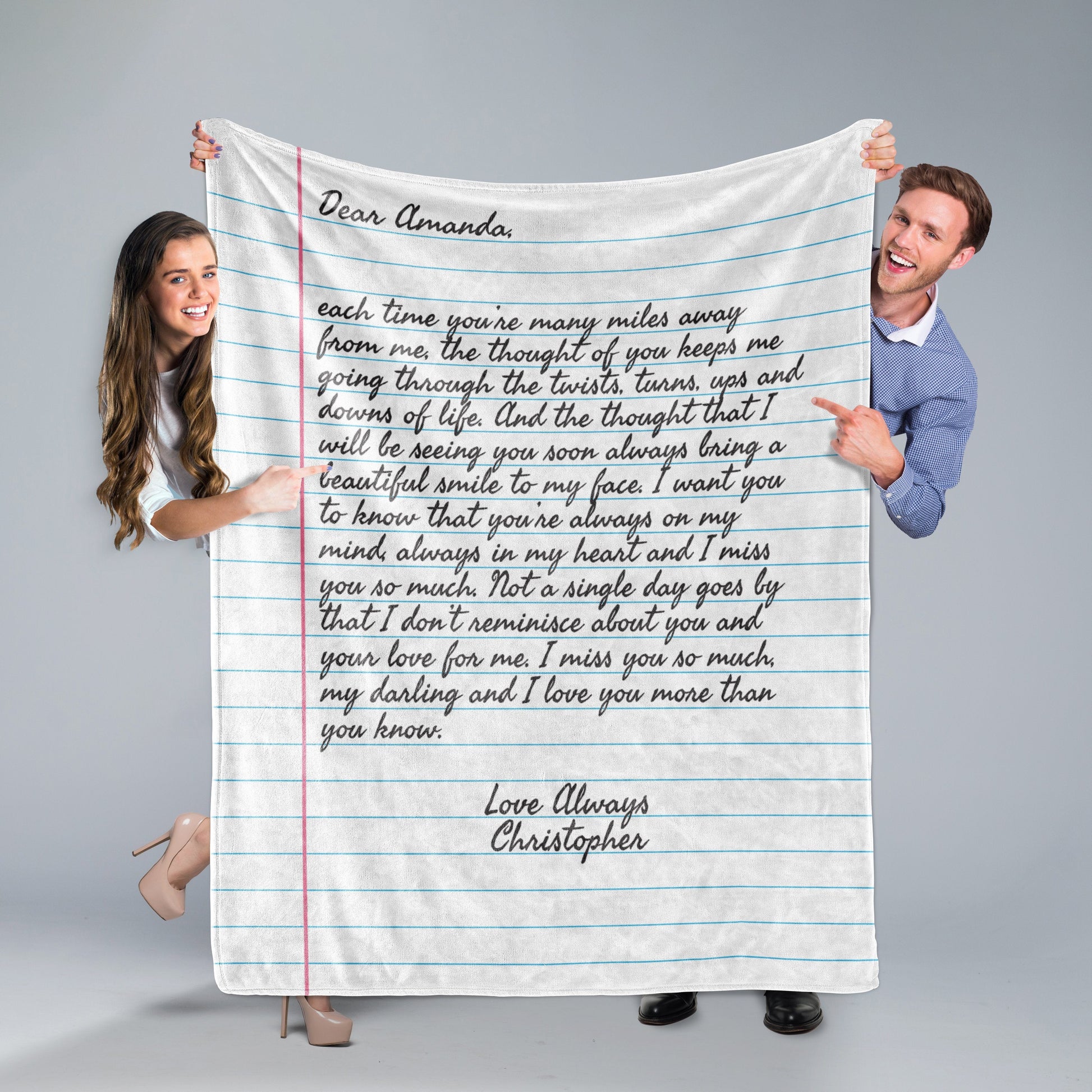 A man and a woman holding a Custom Letter Note Throw Blanket Ruled Paper on grey background