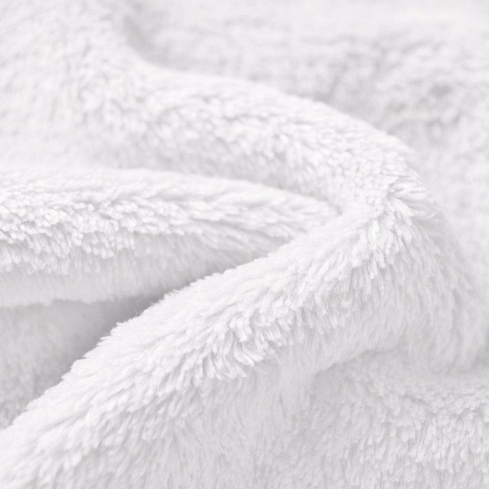 Close up of a white fleece blanket on a white surface