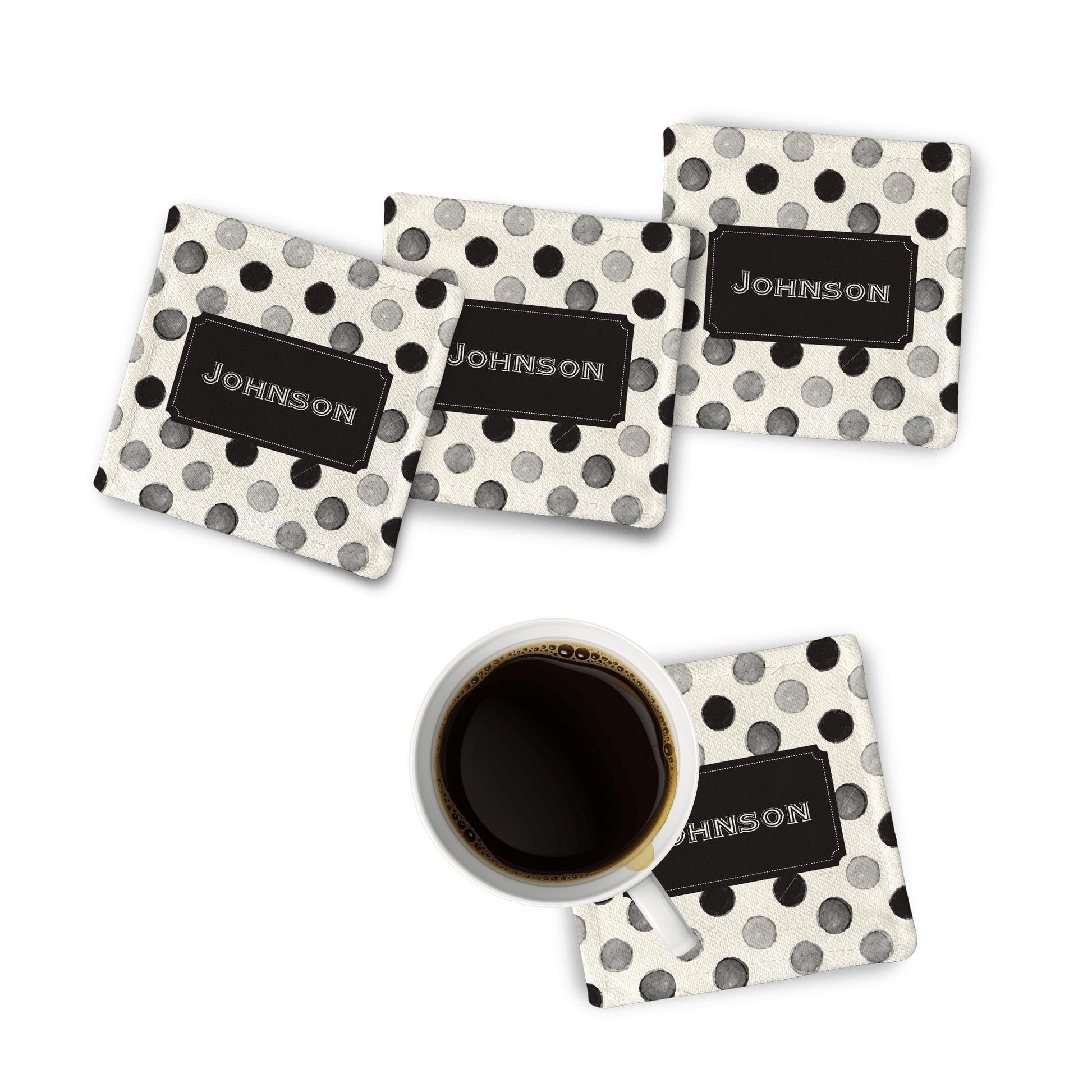 4 Black Polkadot Fabric Coasters on a white surface with black coffee mug