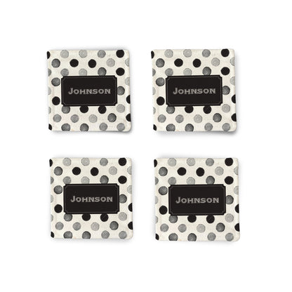 A set of 4 Personalized Black Polkadot Fabric Coasters on a white surface