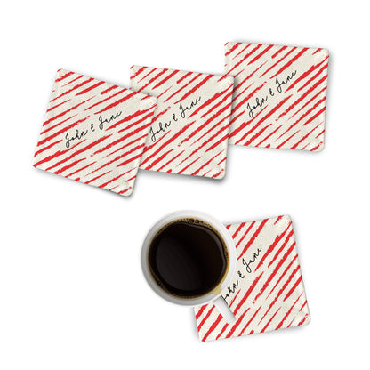 4 personalized Strokes of Love Fabric Coasters and a black coffee mug on a white surface