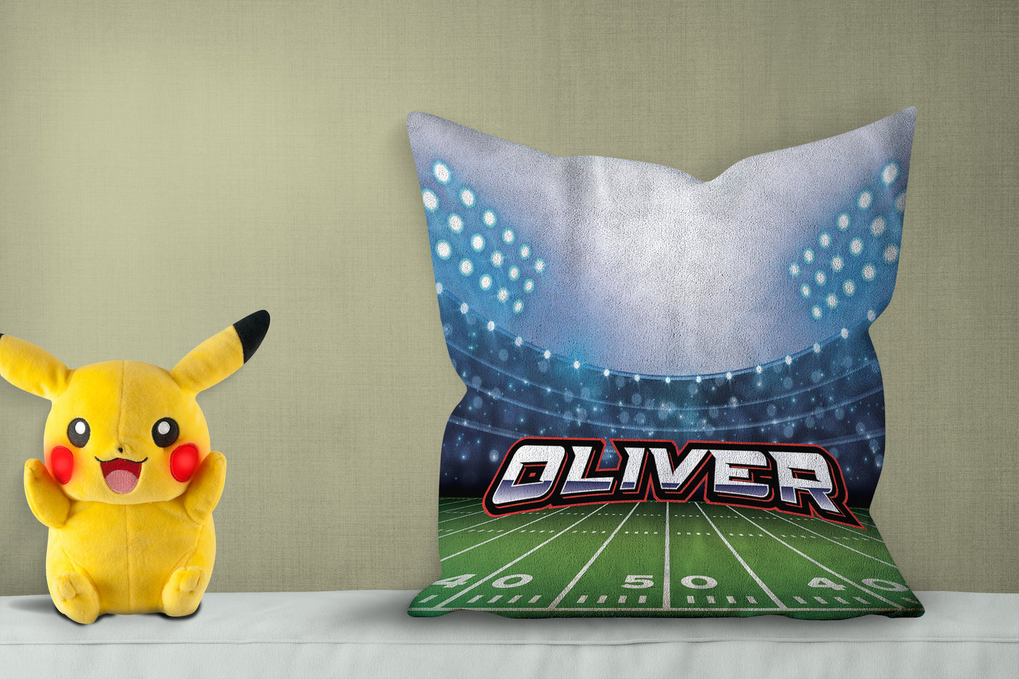 Personalized pillow with "Olivver," showing a Football field design, pikachoo soft toy on side