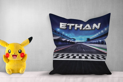 Personalized pillow with "Ethan," showing a race track design, pikachoo soft toy on side