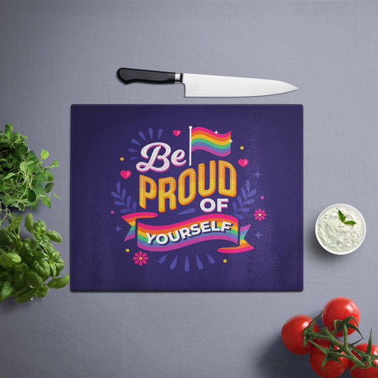 A Glass Cutting Board with Be Proud Of Yourself Pride design on a grey surface