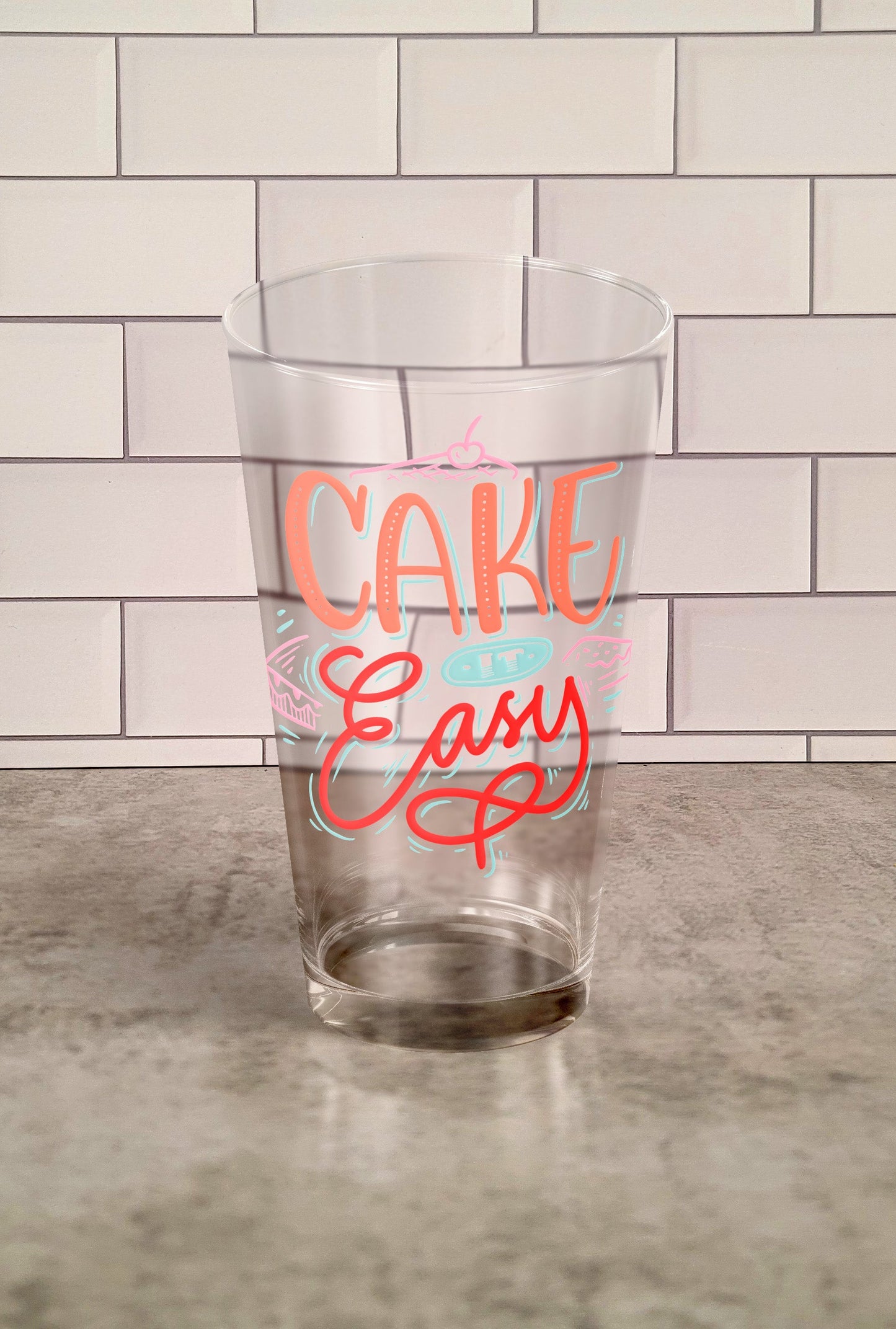 Cake It Easy transparent Tumbler Glass against a slipslap wall