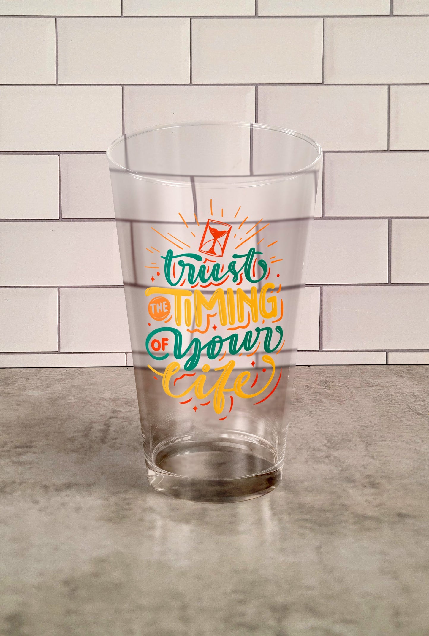 Trust The Timing Of Your Life transparent Tumbler Glass against a slipslap wall