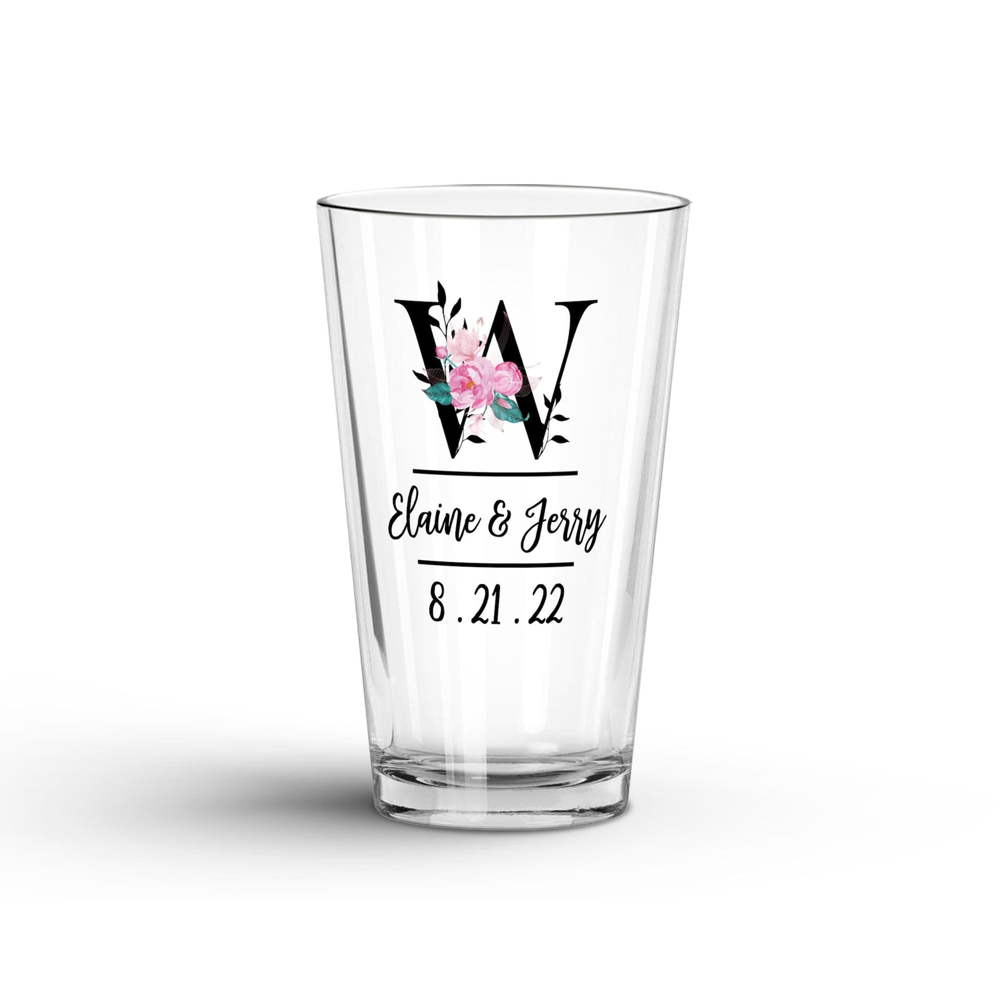 Personalized pint glass featuring a floral initial "W," names "Elaine & Jerry," and the date "8.21.22" in elegant script.