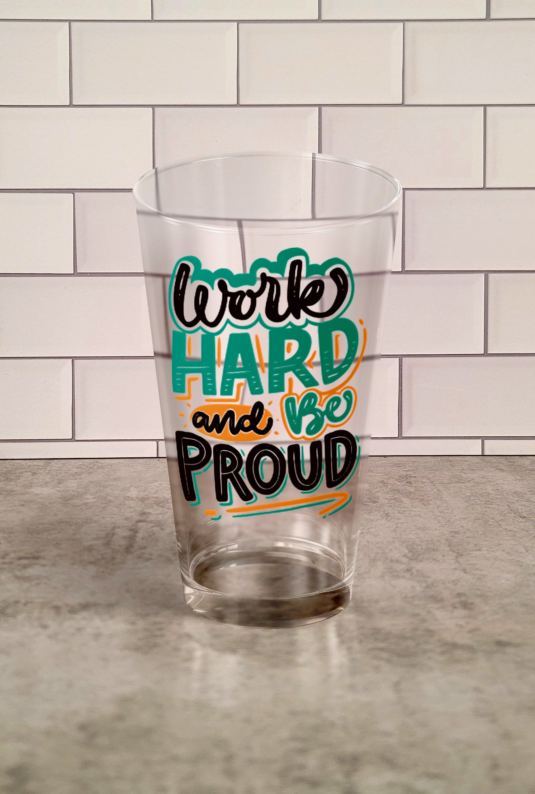 Work hard And Be Proud transparent Tumbler Glass against a slipslap wall