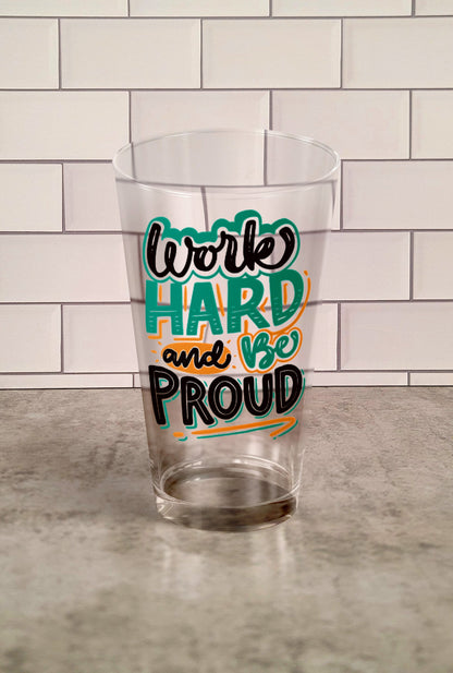 Work hard And Be Proud transparent Tumbler Glass against a slipslap wall