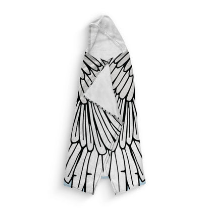 A folded hooded blanket featuring Angel wing designs on a white background. The interior lining is white with a white hood.