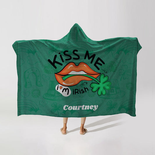 Person wearing a green hooded blanket with "Kiss Me I'm Irish" text, orange lips, a clover, and the name "Courtney" at the bottom.