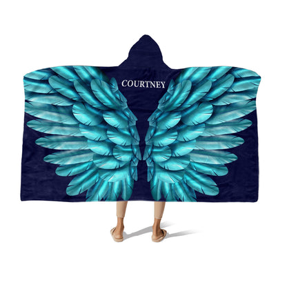 Person wearing a Hooded Fleece Blanket: Turquoise Wings design and a customized name Courtney