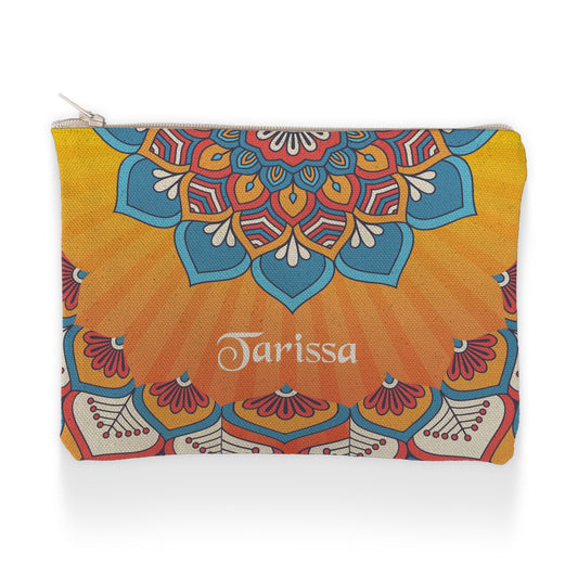 A vibrant, colorful pouch with an intricate mandala pattern in blue, red, and yellow, personalized with the name "Tarissa" in elegant white script.