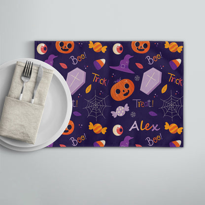 Personalized purple placemat featuring cute orange pumpkin, coffin, and candy with the customized name "Alex" printed.