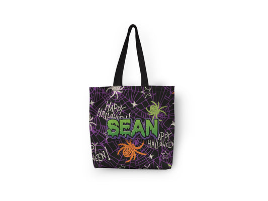 A black tote bag with white background and purple web on it, with customized name in spooky font written in green