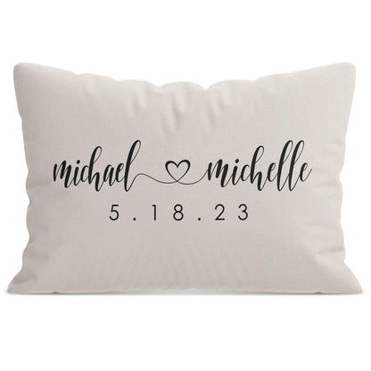 A white Personalized Wedding Monogram Throw Pillow with personalized names michael and michelle