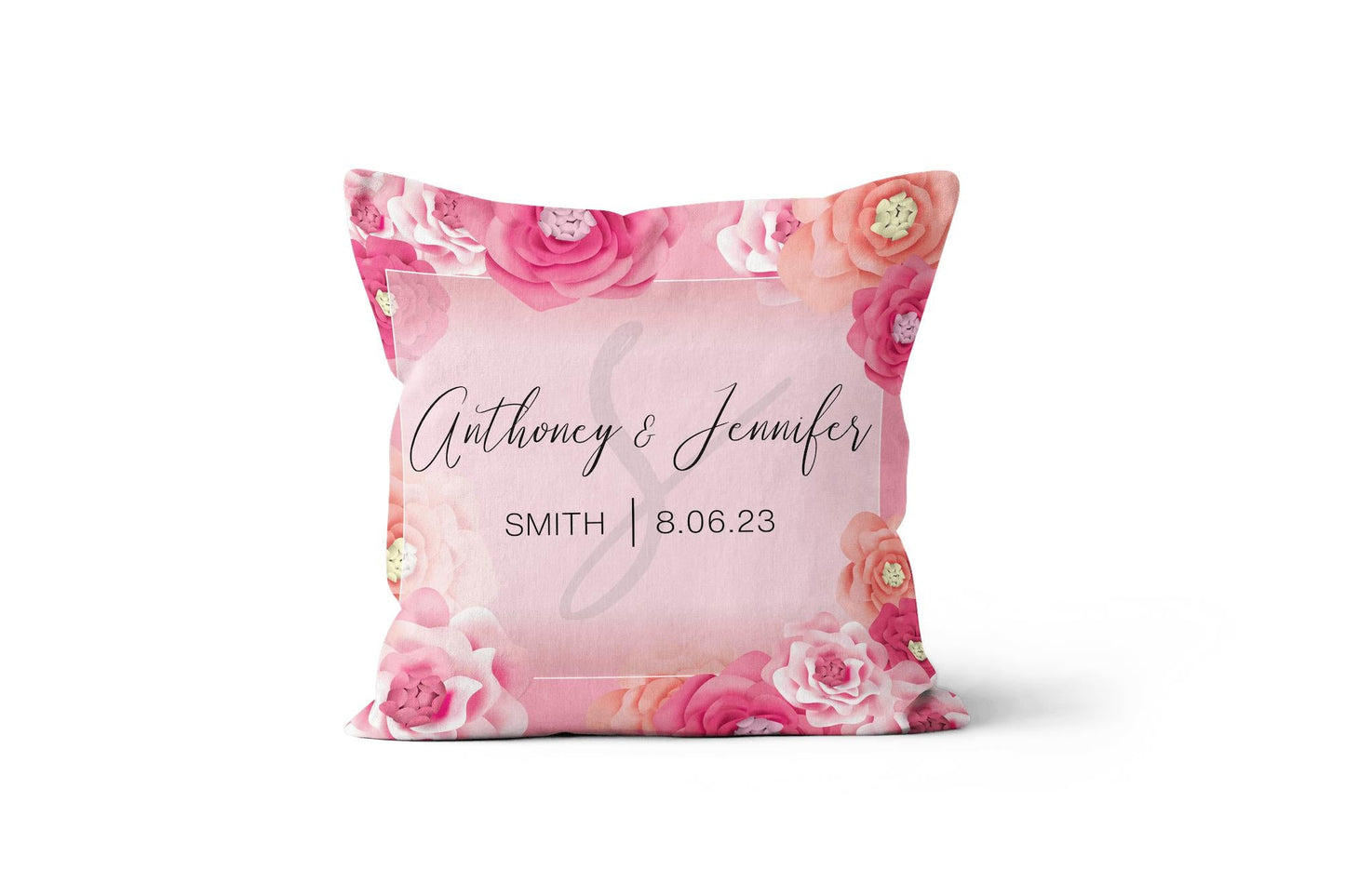 A Personalized Wedding Monogram Throw Pillow with roses printed on a white background