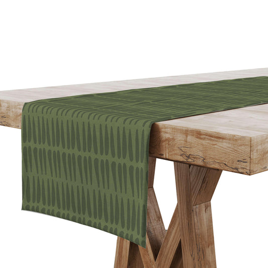 A Green Tribal Table Runner displayed on a wooden dining table