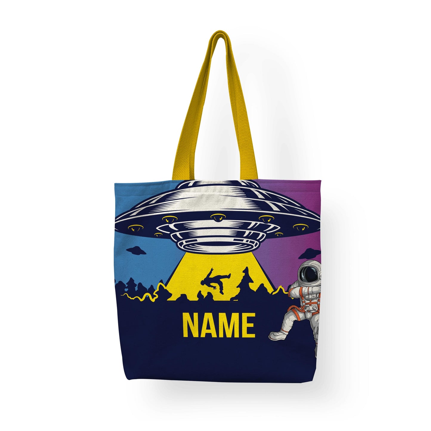 A tote bag with Alien Invasion displayed on a white surface with yellow handle